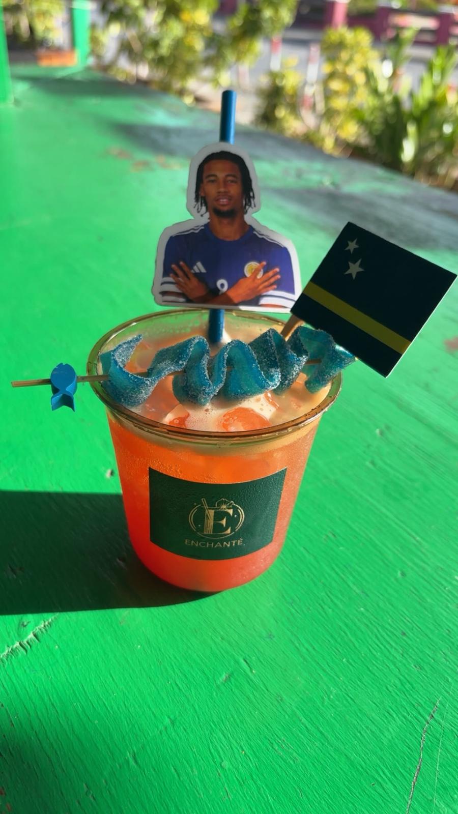 Curaçao football cocktail with blue candy and flag