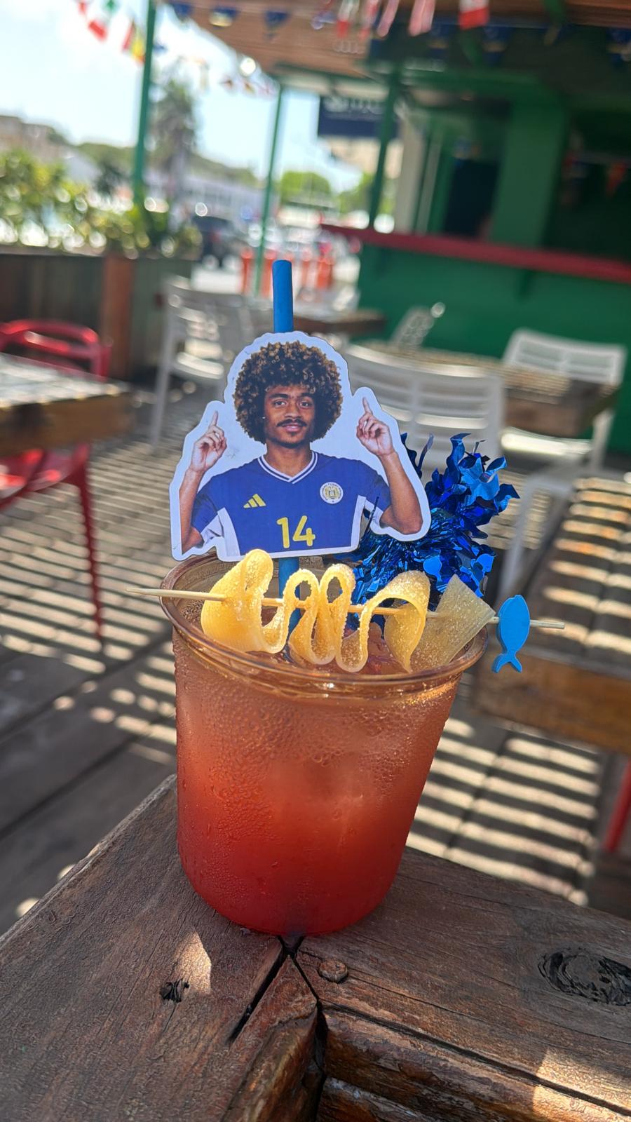 Personalized football cocktail with yellow candy and blue decorations